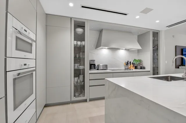 a kitchen with a sink stainless steel appliances and cabinets