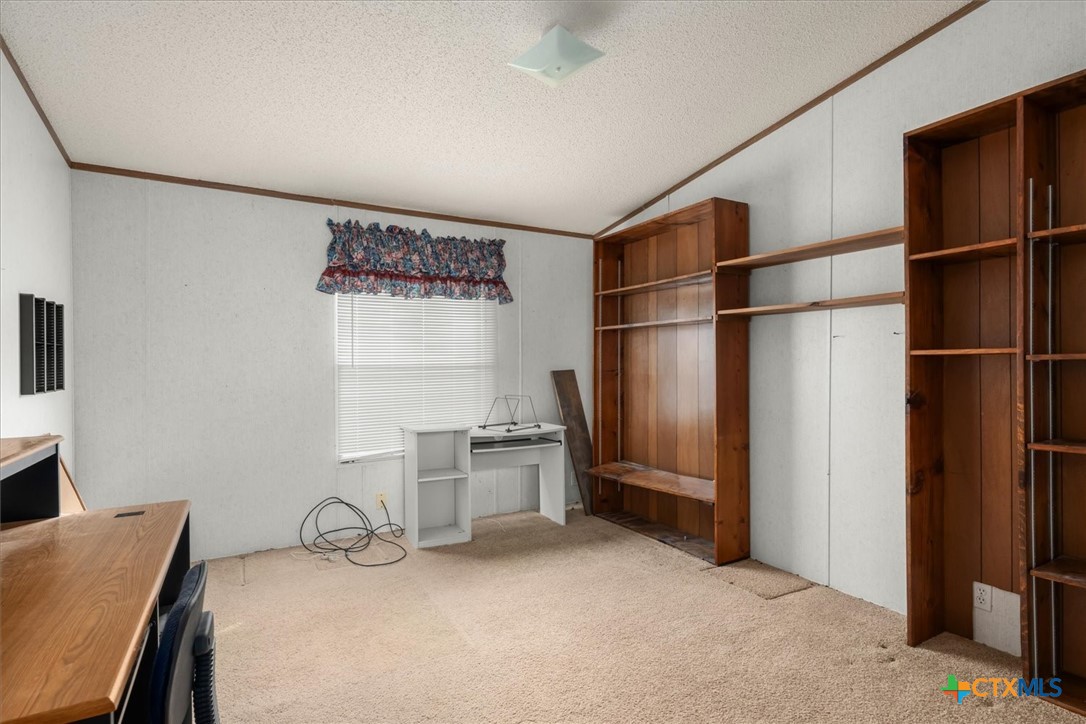 14858 Farm To Market Road 1322 Luling, TX 78648 - Photo 12 of 40 a room with a refrigerator and a stove top oven