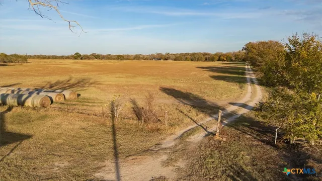 a view of a house with a yard and lake view