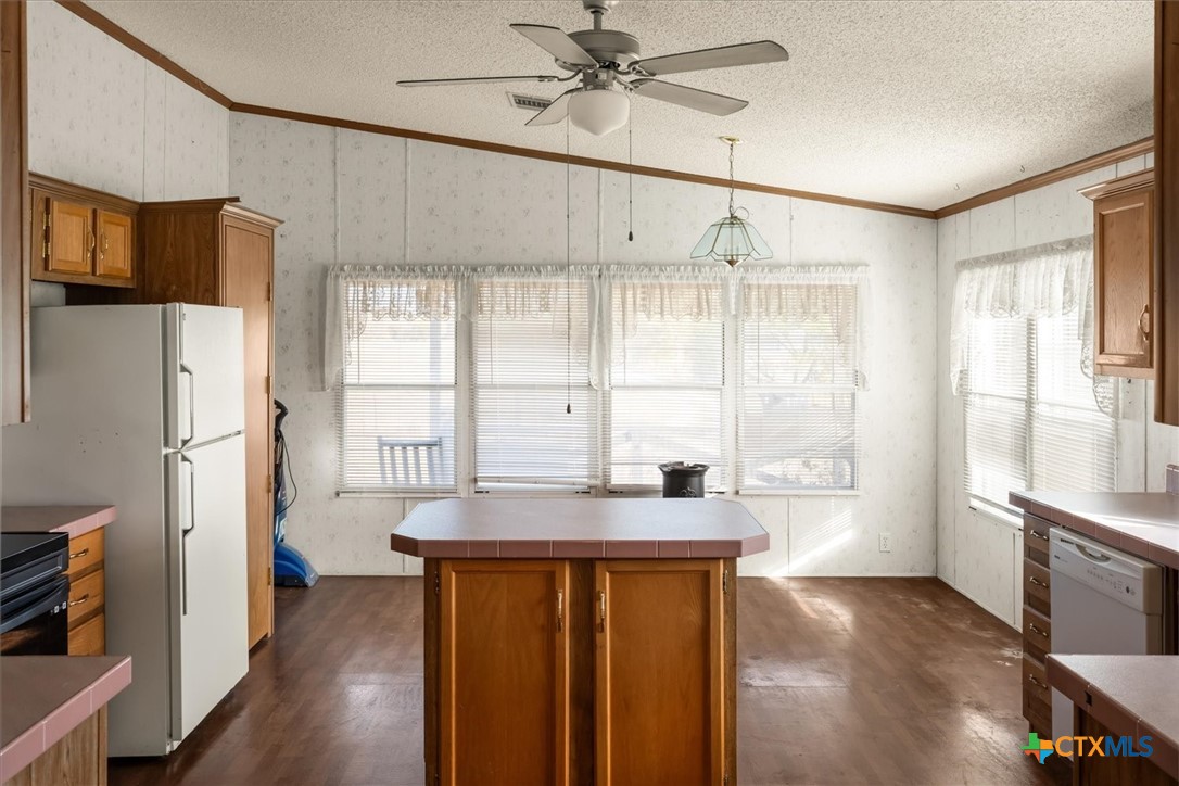 14858 Farm To Market Road 1322 Luling, TX 78648 - Photo 5 of 40 a kitchen with stainless steel appliances granite countertop a refrigerator a sink and white cabinets