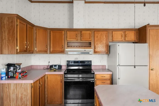 a kitchen with appliances cabinets and a sink