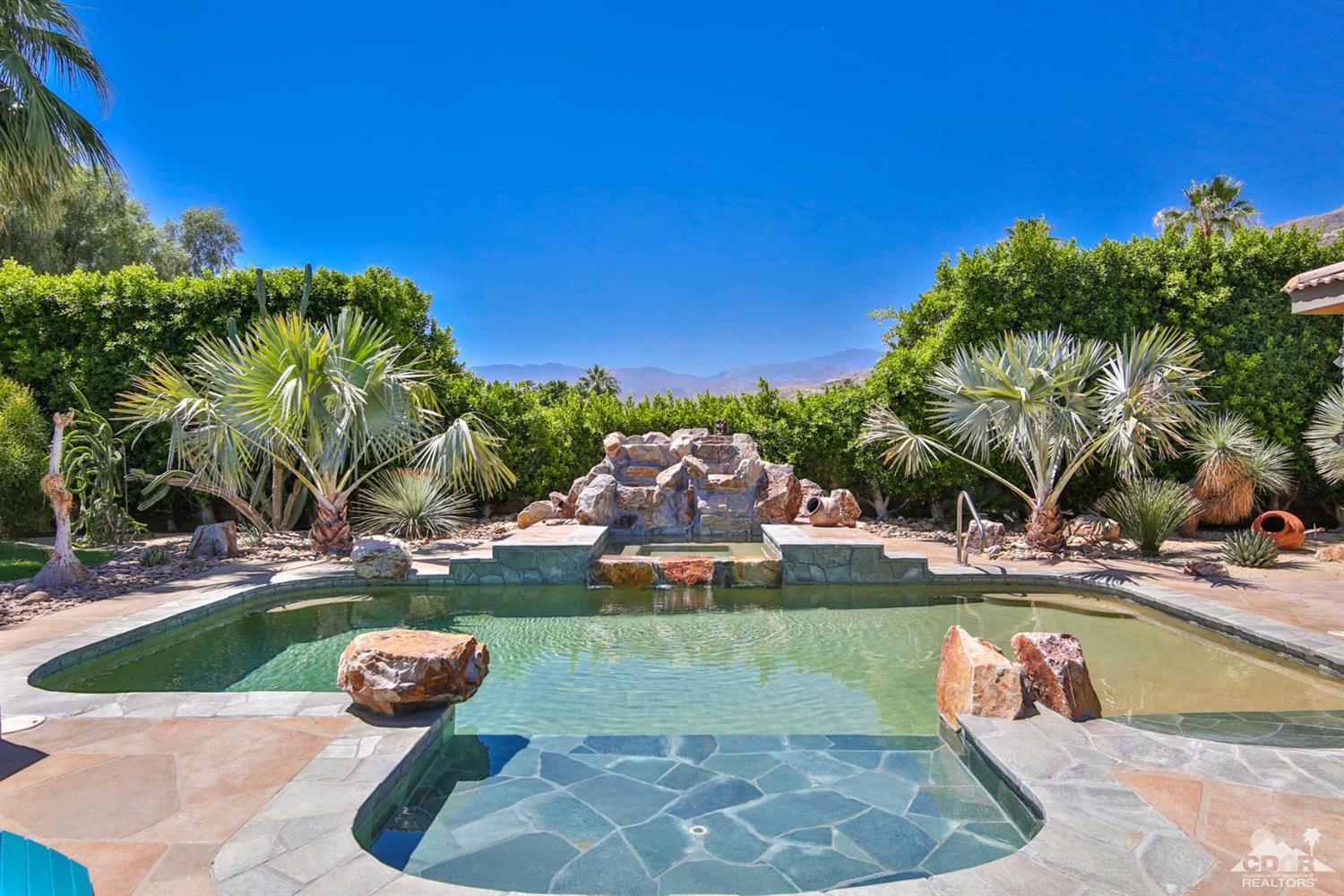 72187 Rancho Road Rancho Mirage, CA 92270 - Photo 2 of 25 a view of a swimming pool with a yard