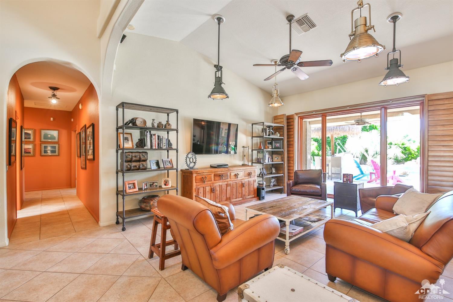 72187 Rancho Road Rancho Mirage, CA 92270 - Photo 12 of 25 a living room with furniture a ceiling fan and a window