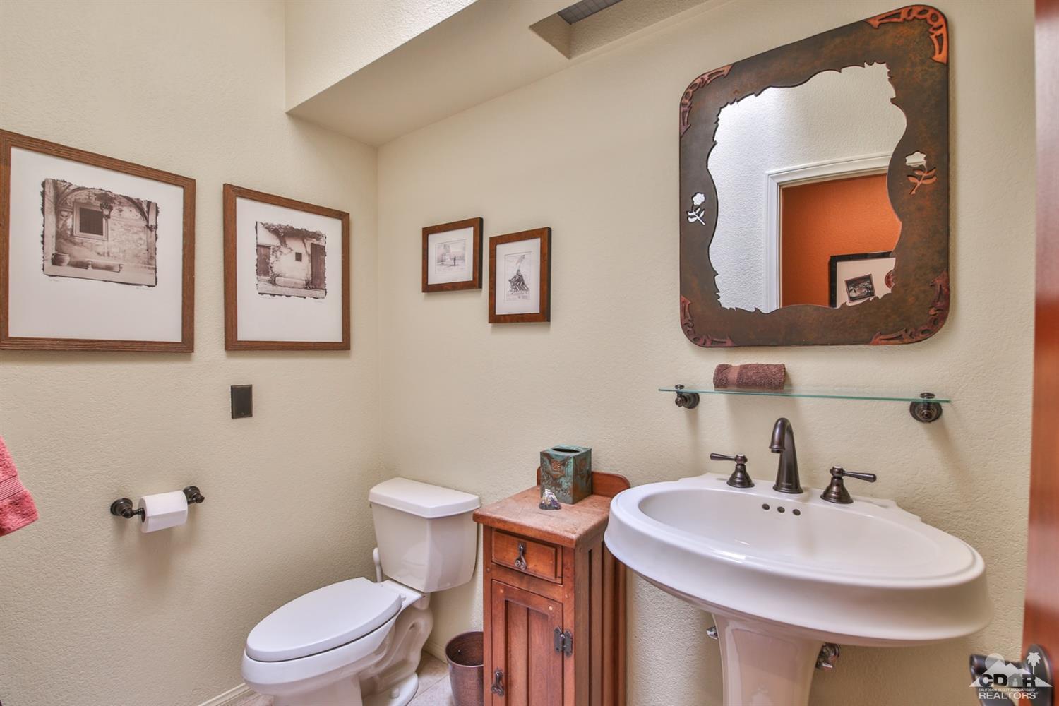72187 Rancho Road Rancho Mirage, CA 92270 - Photo 16 of 25 a bathroom with a toilet sink and mirror