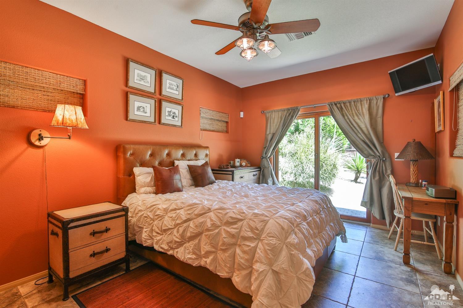 72187 Rancho Road Rancho Mirage, CA 92270 - Photo 21 of 25 a bedroom with a bed a dresser next to a window