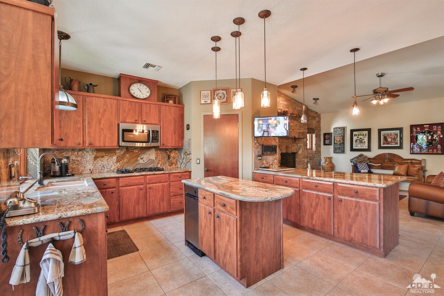 72187 Rancho Road Rancho Mirage, CA 92270 - Photo 9 of 25 a kitchen with stainless steel appliances granite countertop a stove a sink and a refrigerator