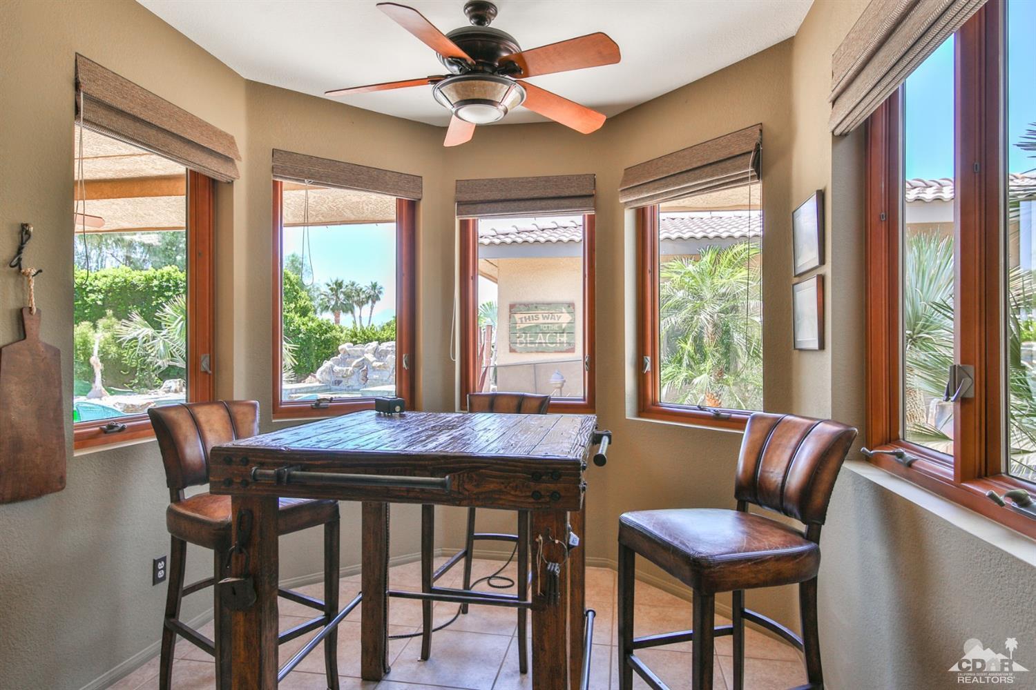 72187 Rancho Road Rancho Mirage, CA 92270 - Photo 10 of 25 a dining room with furniture a chandelier and wooden floor