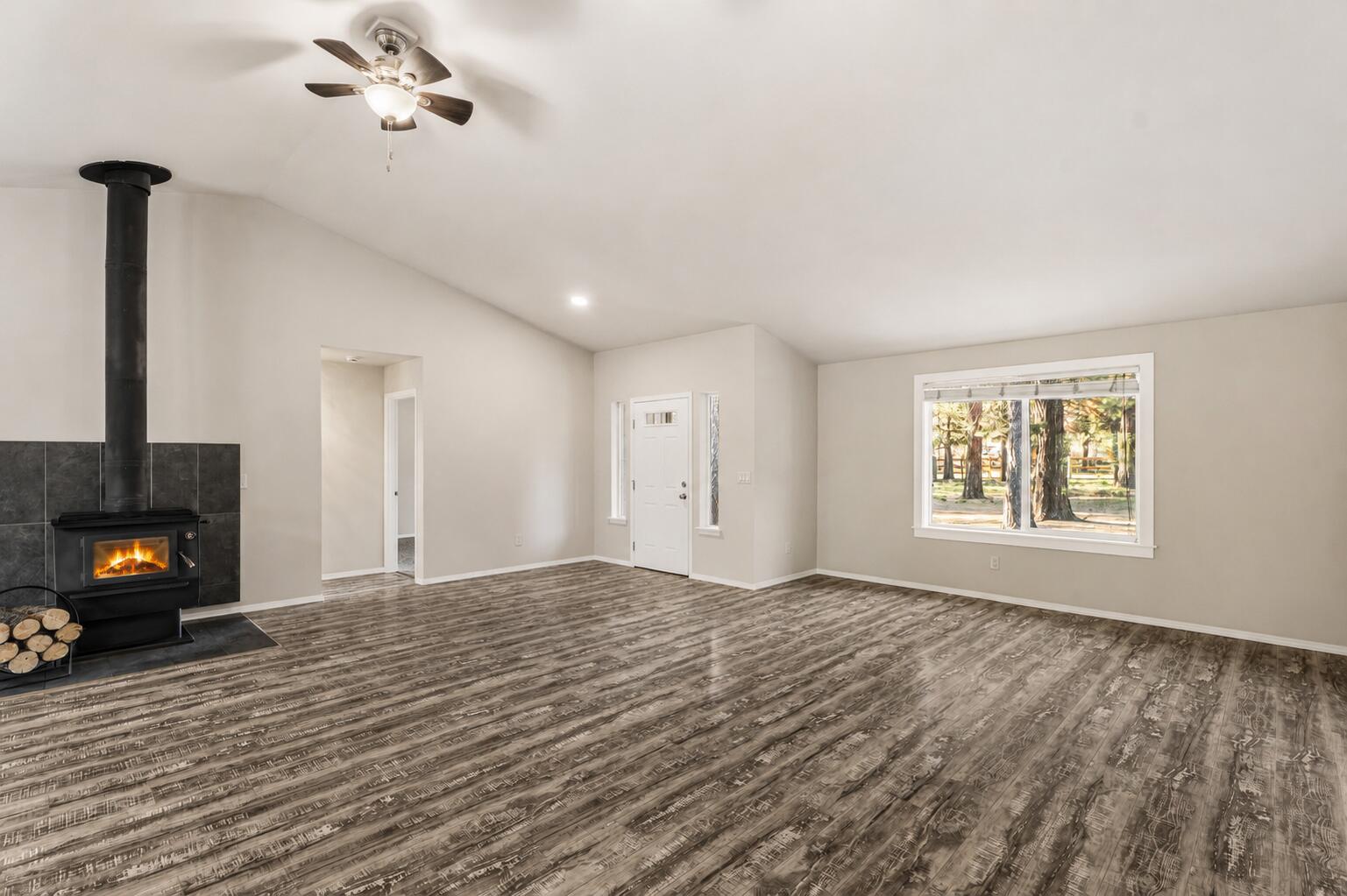 16050 Dick Road La Pine, OR 97739 - Photo 7 of 59 a view of an empty room with a window and a fireplace