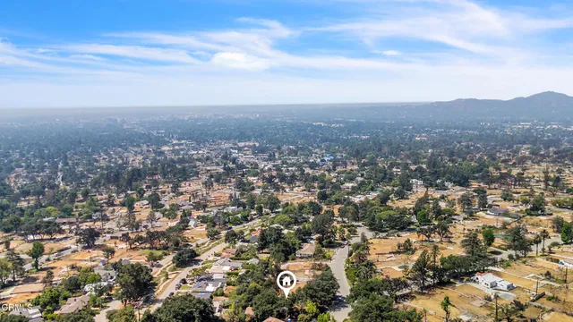 an aerial view of houses covered in trees