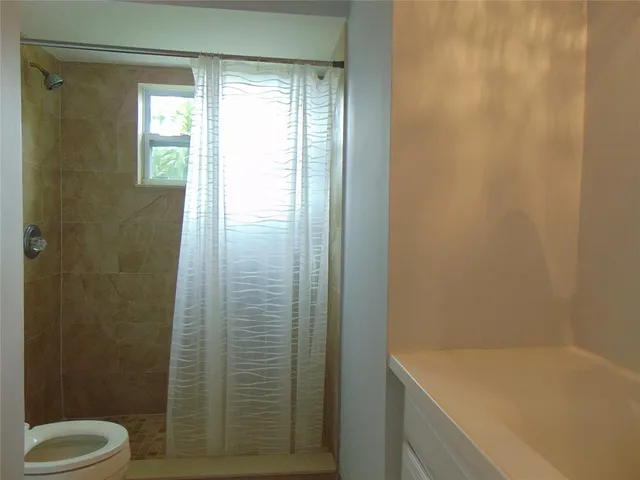 a bathroom with a shower and a toilet