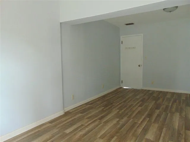 a backyard of a house with lots of green space and fountain