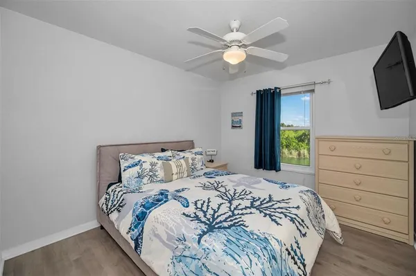 a bed room with a bed and a chandelier