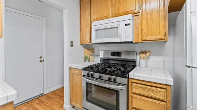 a kitchen with stainless steel appliances granite countertop a stove and a microwave