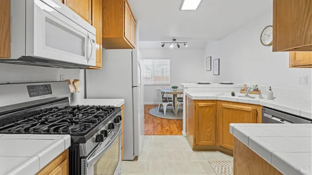 a kitchen with a stove a sink and a refrigerator