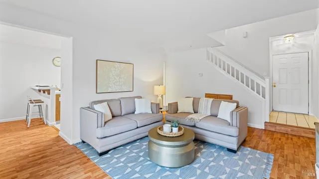 a living room with furniture and a dining table