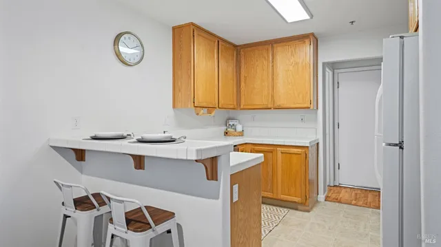a view of a kitchen with a sink and a refrigerator