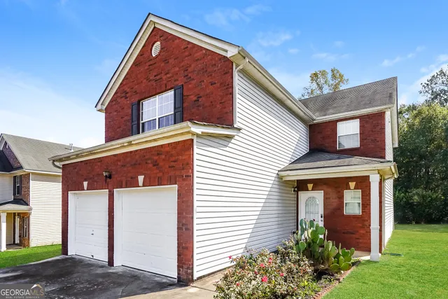 a front view of a house with garden