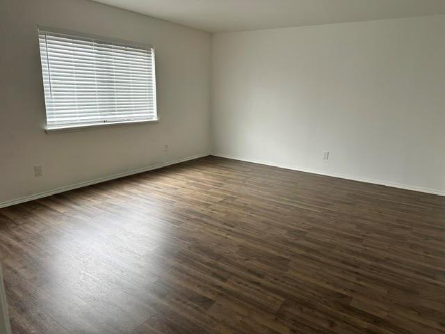 3413 Apollo Road Garland, TX 75044 - Photo 13 of 19 an empty room with wooden floor and windows