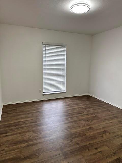 3413 Apollo Road Garland, TX 75044 - Photo 17 of 19 an empty room with wooden floor and windows