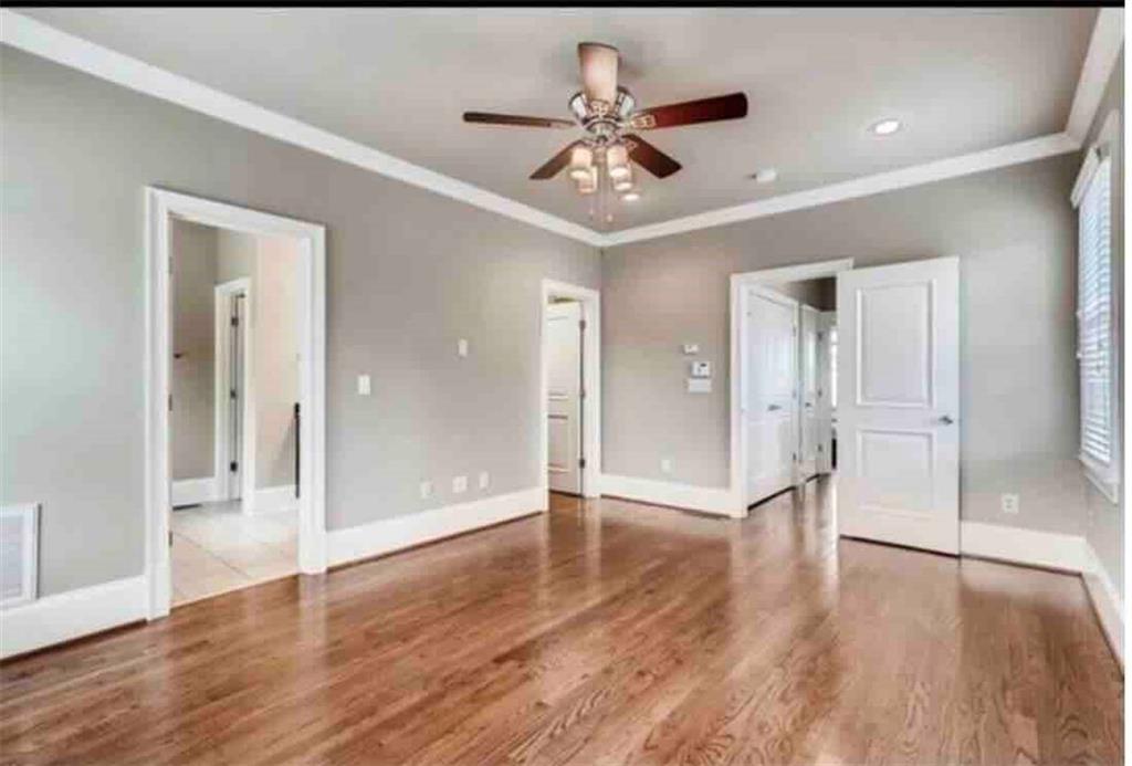384 16th Street Northwest, Unit 1 Atlanta, GA 30363 - Photo 21 of 31 a view of an empty room with wooden floor and a ceiling fan