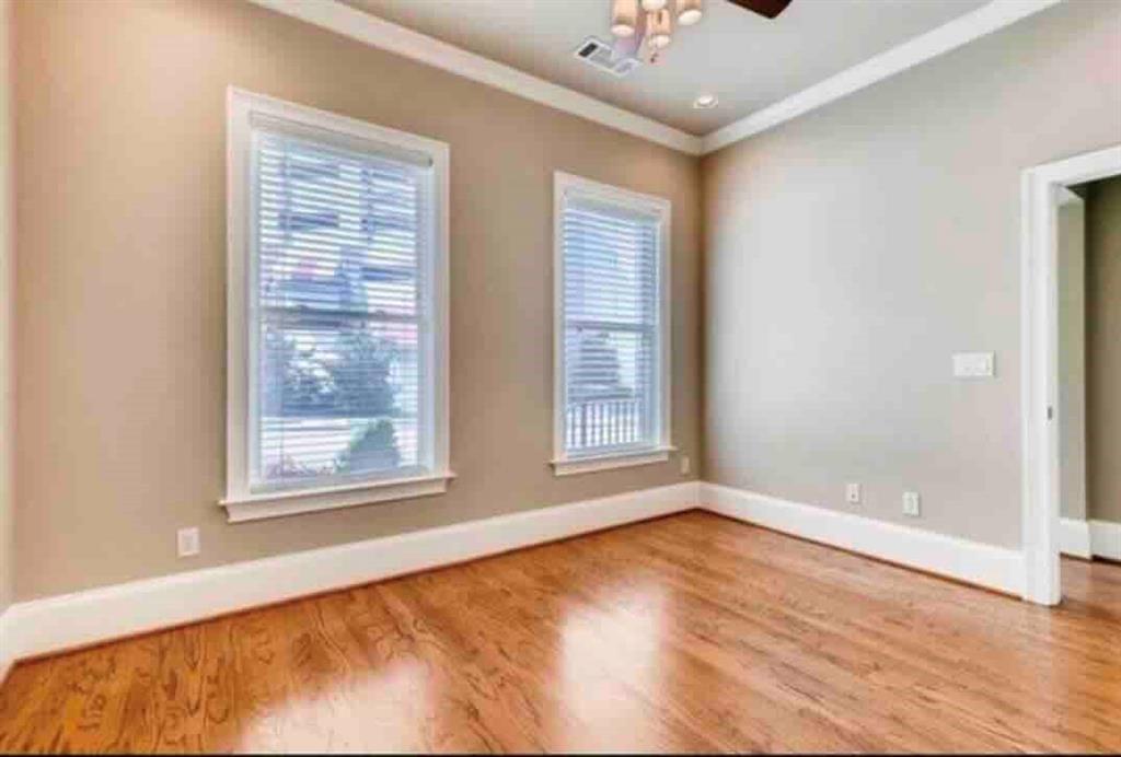 384 16th Street Northwest, Unit 1 Atlanta, GA 30363 - Photo 8 of 31 a view of an empty room with a window and wooden floor