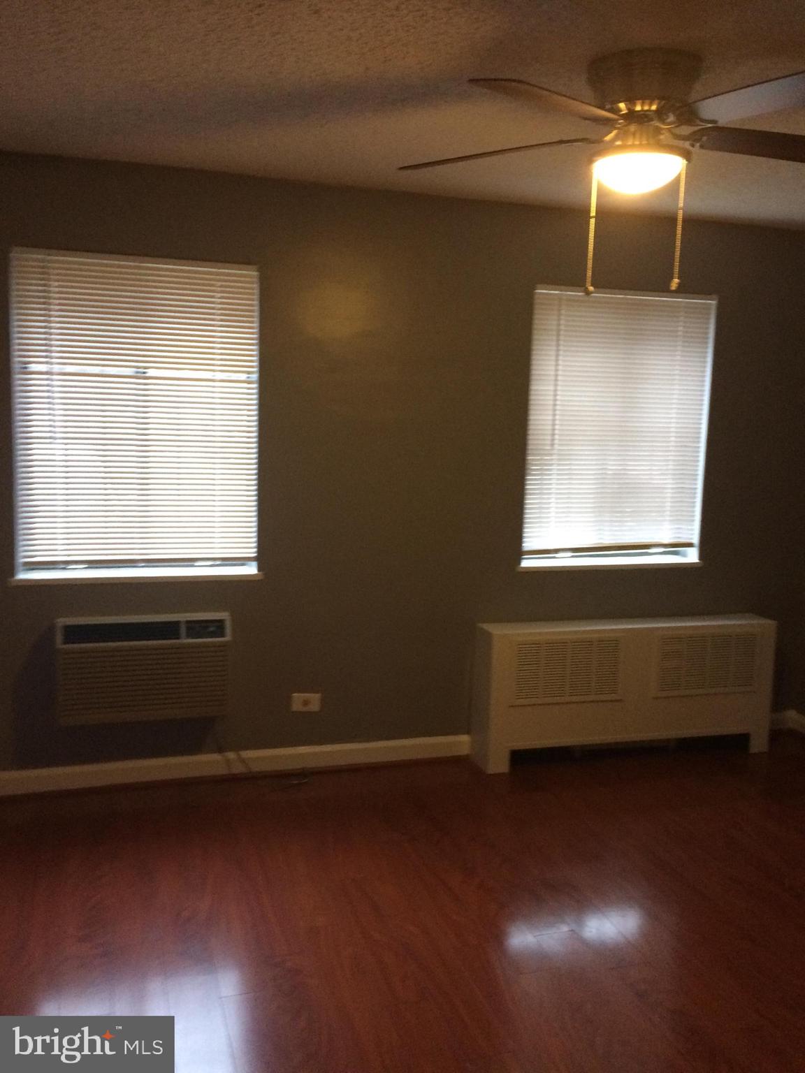 4721 1st Street Southwest, Unit 101 Washington, DC 20032 - Photo 7 of 12 a room with wooden floor and a window