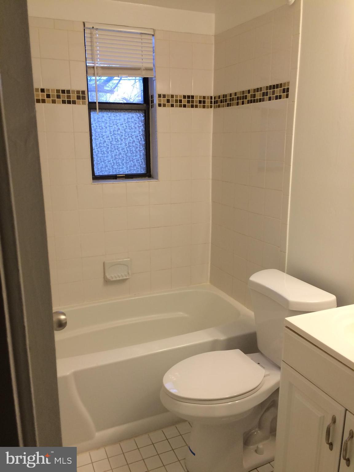 4721 1st Street Southwest, Unit 101 Washington, DC 20032 - Photo 8 of 12 a bathroom with a toilet and a shower