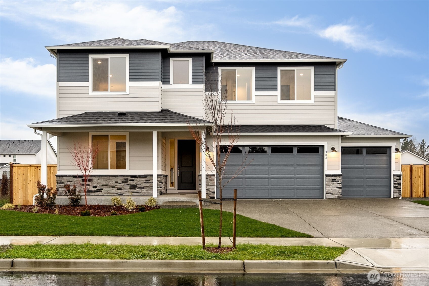 984 Tanner Avenue, Unit 101 Buckley, WA 98321 - Photo 1 of 17 a front view of a house with a garden