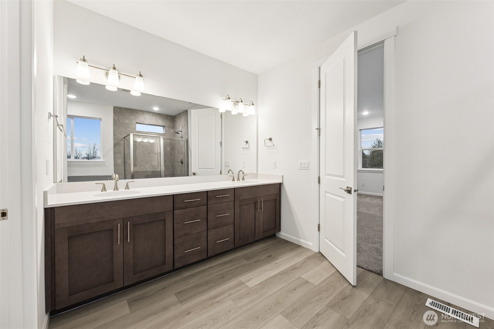 984 Tanner Avenue, Unit 101 Buckley, WA 98321 - Photo 14 of 17 a spacious bathroom with a double vanity sink and a mirror