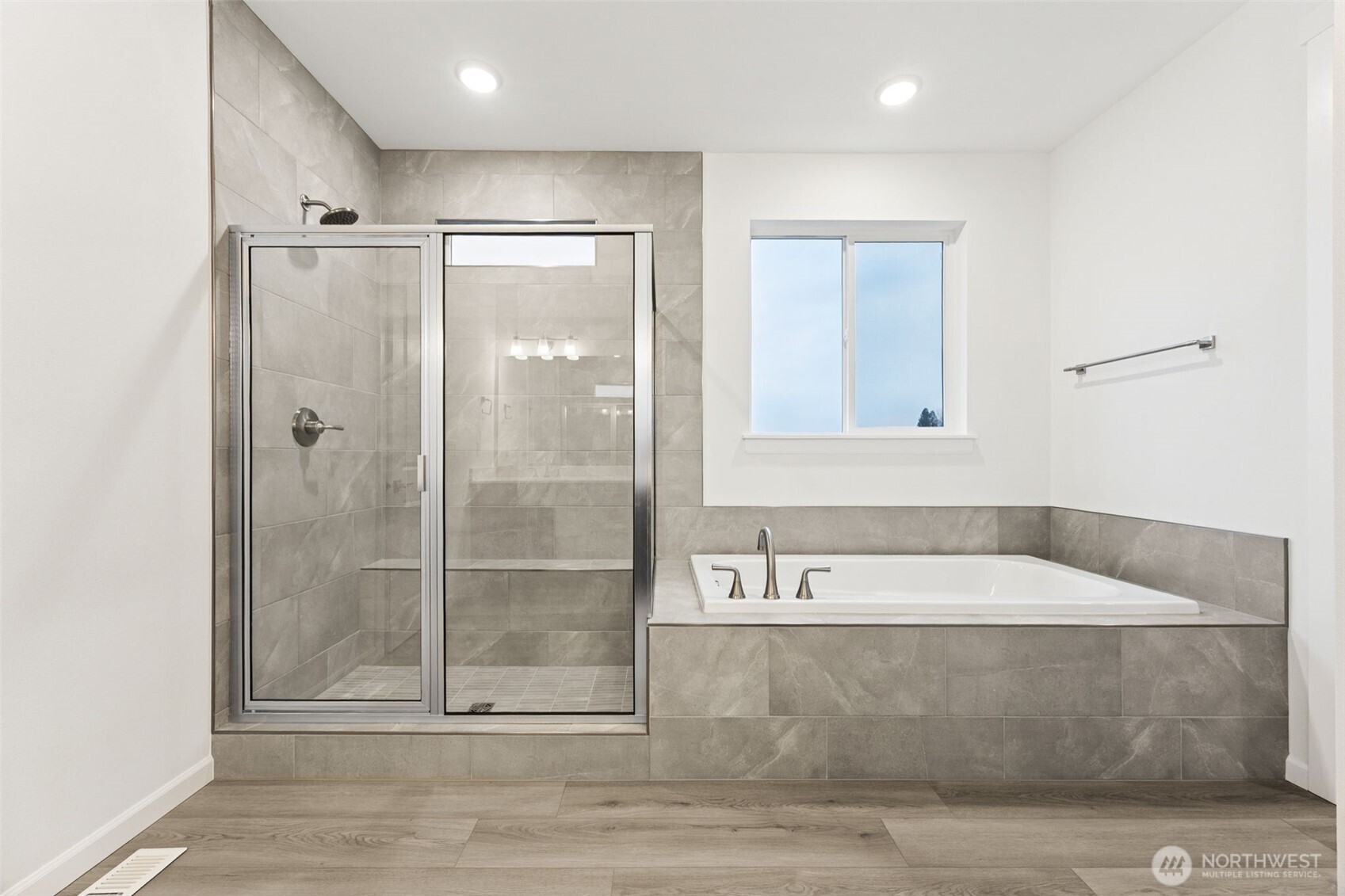 984 Tanner Avenue, Unit 101 Buckley, WA 98321 - Photo 15 of 17 a bathroom with a tub a sink and a shower
