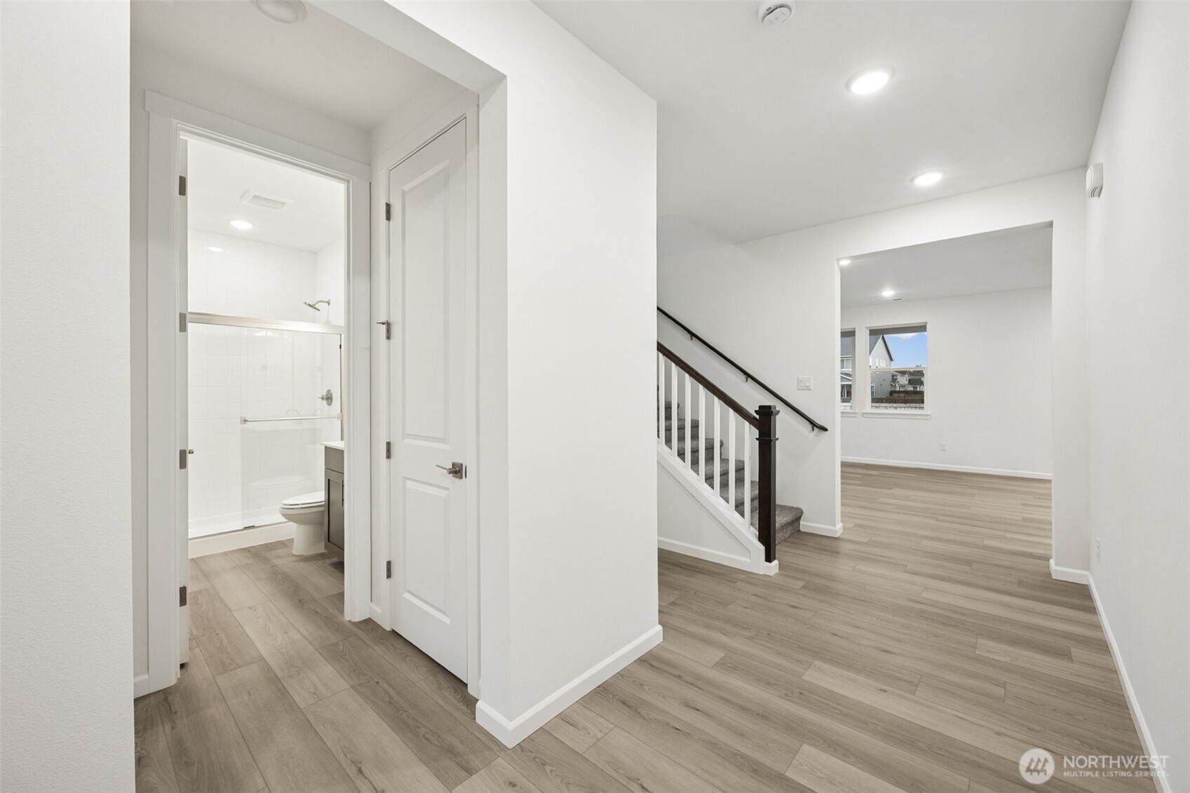 984 Tanner Avenue, Unit 101 Buckley, WA 98321 - Photo 5 of 17 a view of a hallway with the wooden floor and staircase