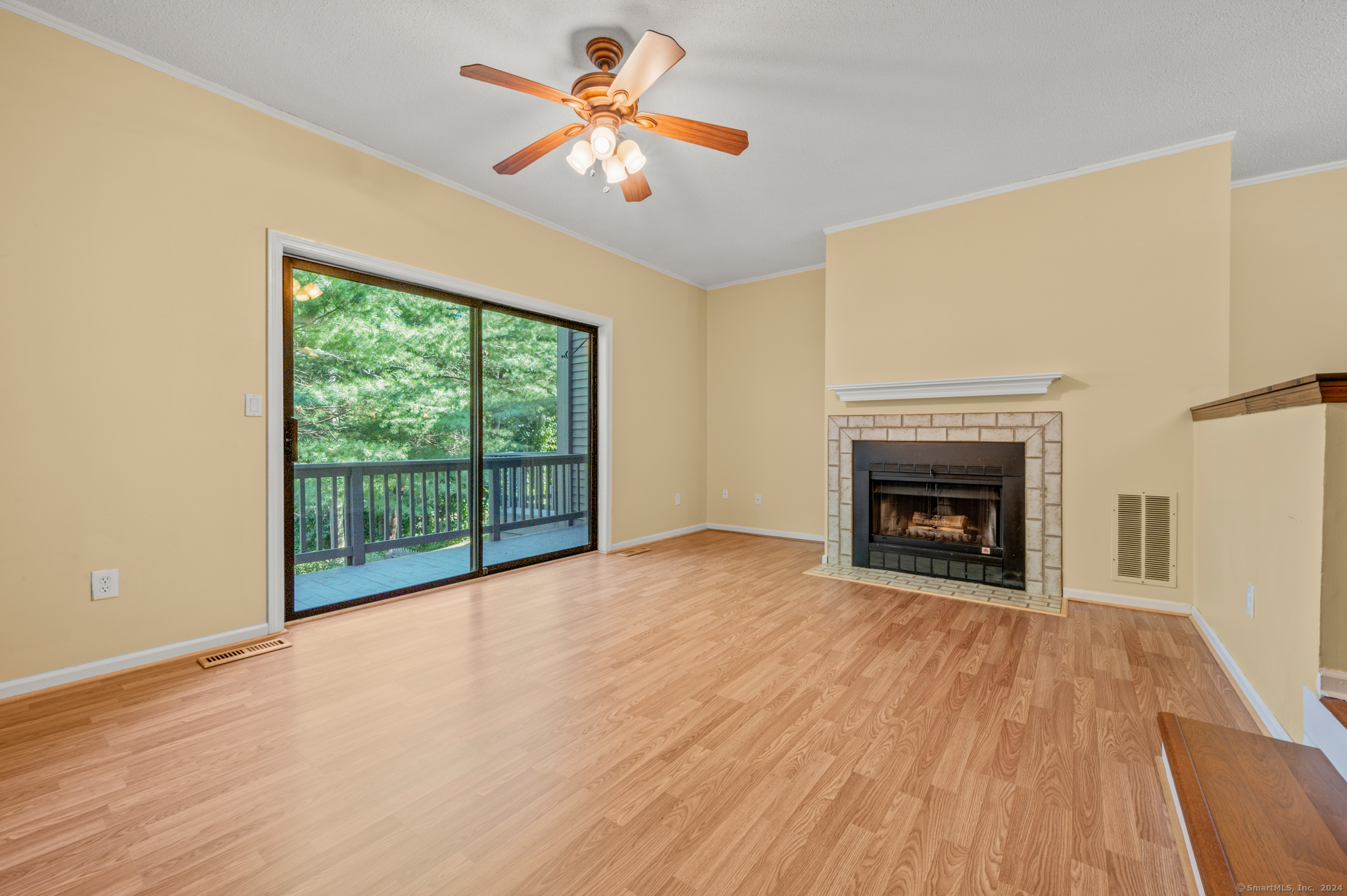 250 Conestoga Way, Unit 250 Glastonbury, CT 06033 - Photo 11 of 37 a view of empty room with wooden floor and fireplace