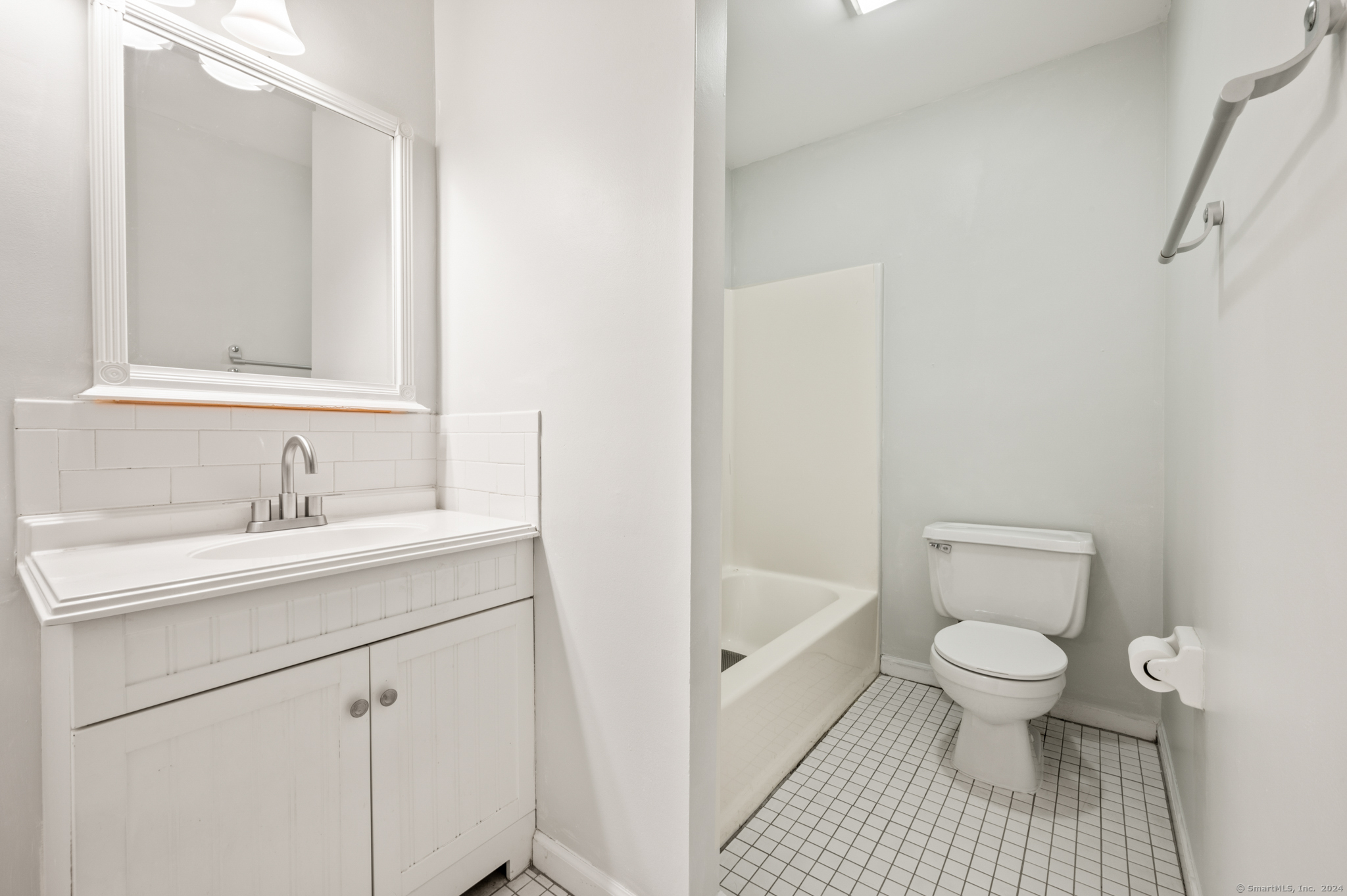 250 Conestoga Way, Unit 250 Glastonbury, CT 06033 - Photo 26 of 37 a bathroom with a sink a toilet and a mirror