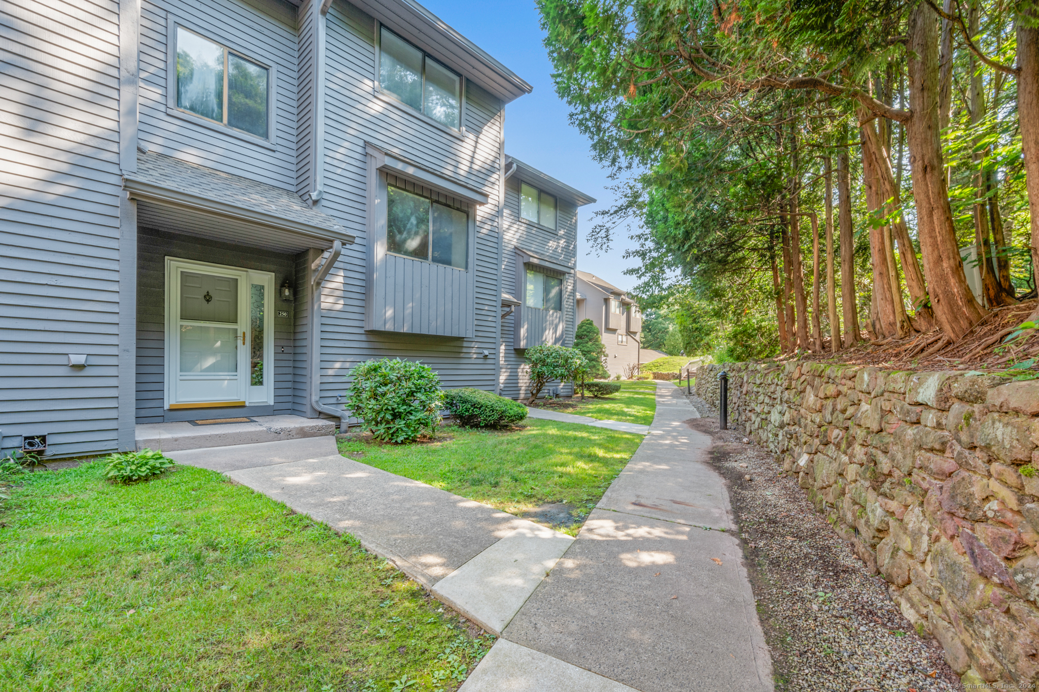 250 Conestoga Way, Unit 250 Glastonbury, CT 06033 - Photo 3 of 37 a front view of a house with a yard