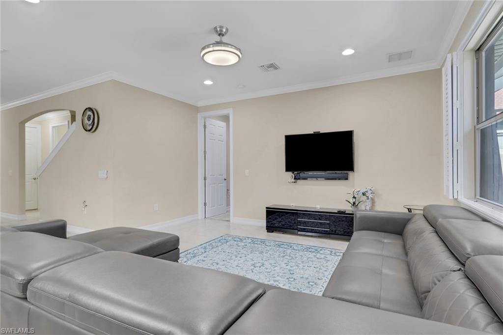 16309 Aberdeen Way Naples, FL 34110 - Photo 11 of 34 a living room with furniture and a flat screen tv