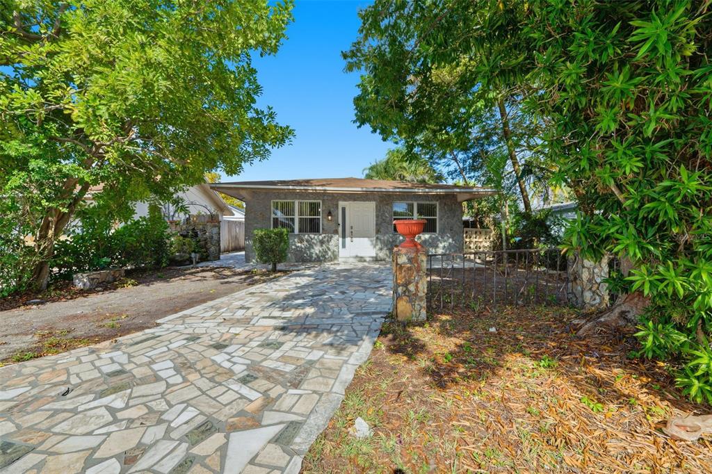 a front view of a house with garden
