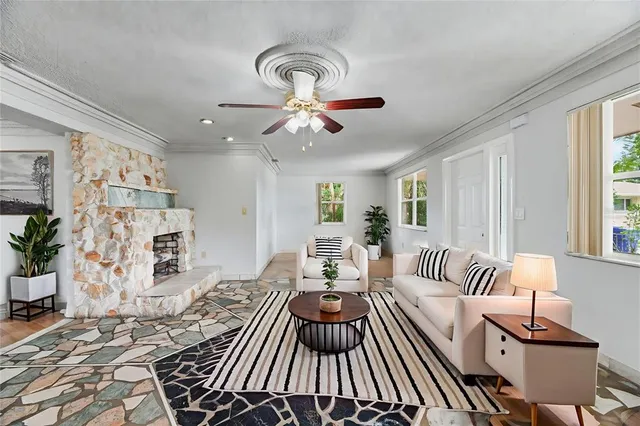 a living room with furniture and a chandelier