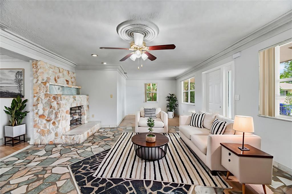 5735 Hayes Street Hollywood, FL 33021 - Photo 2 of 40 a living room with furniture and a chandelier