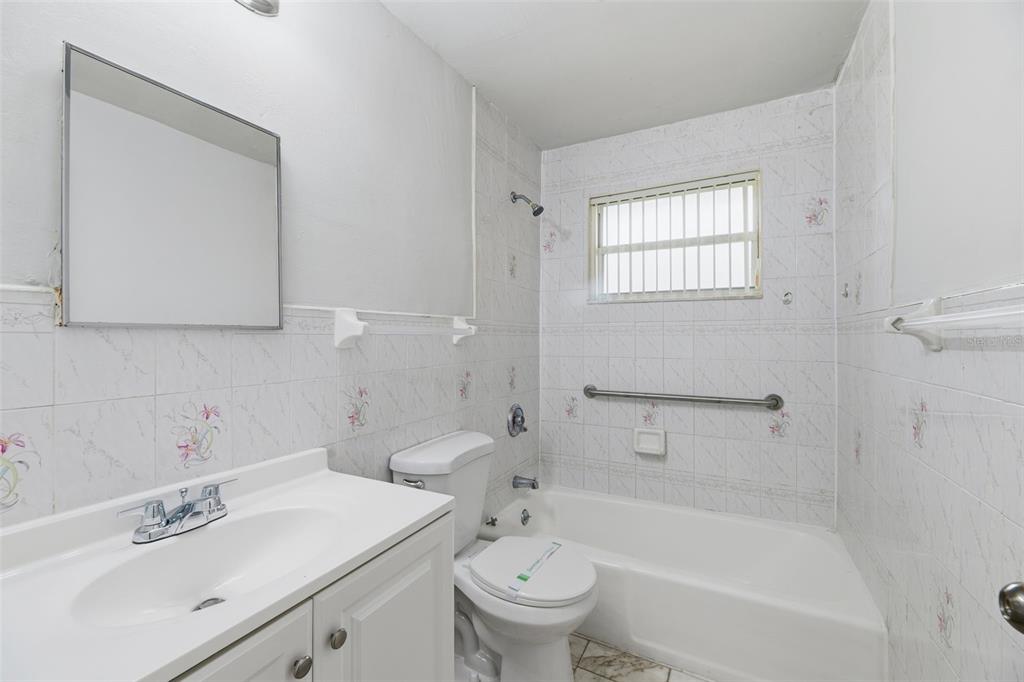 5735 Hayes Street Hollywood, FL 33021 - Photo 25 of 40 a bath room with a toilet a sink and a bath tub