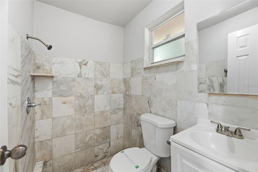 5735 Hayes Street Hollywood, FL 33021 - Photo 27 of 40 a white toilet sitting next to a bathroom sink