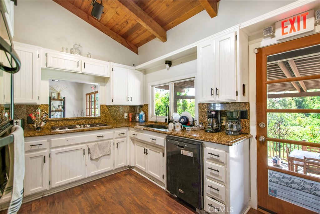 7241 Old Temescal Road Corona, CA 92881 - Photo 27 of 47 a kitchen with a sink window and cabinets