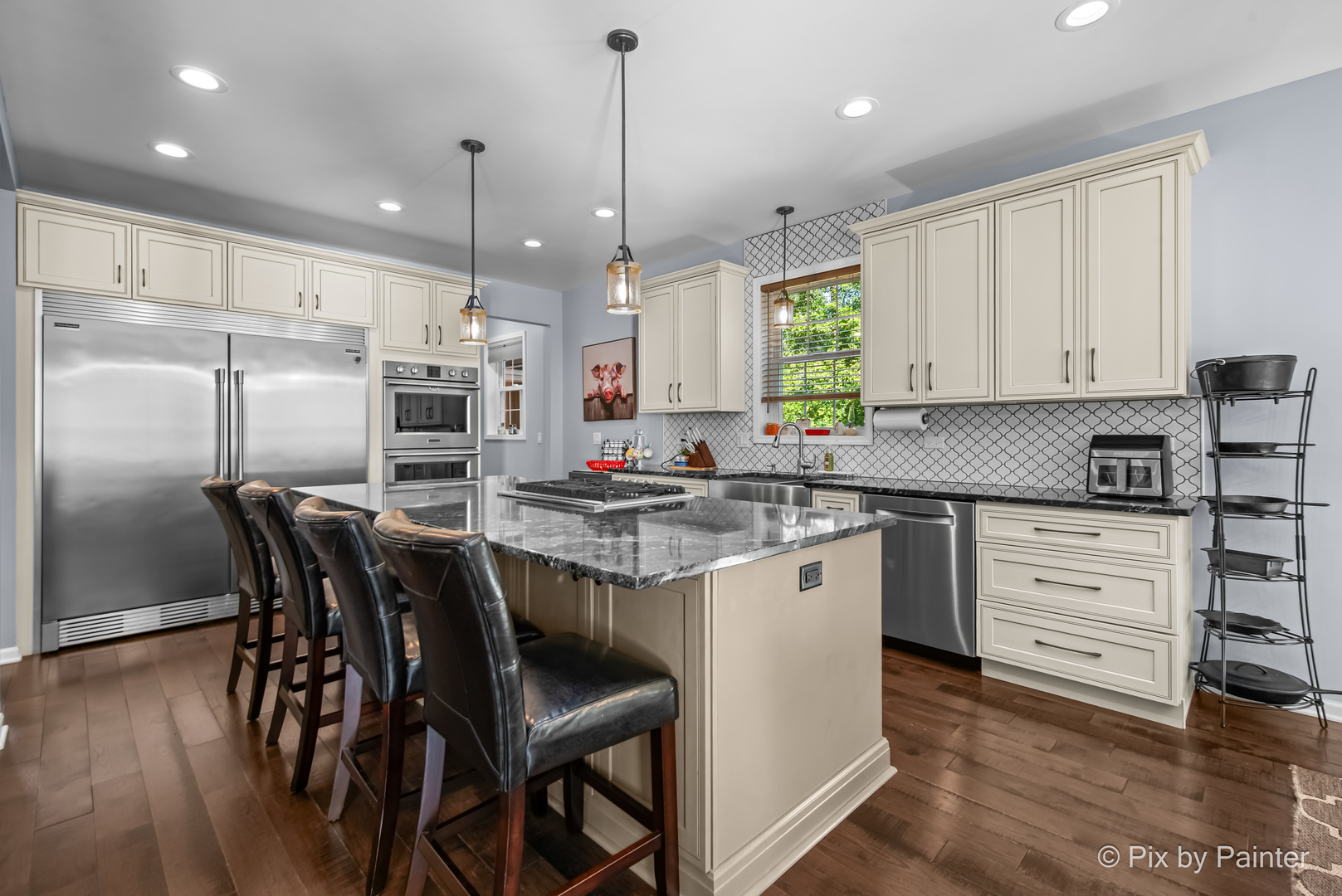 39247 Rangers Way Antioch, IL 60002 - Photo 15 of 53 a kitchen with stainless steel appliances granite countertop a stove a sink refrigerator and white cabinets with wooden floor