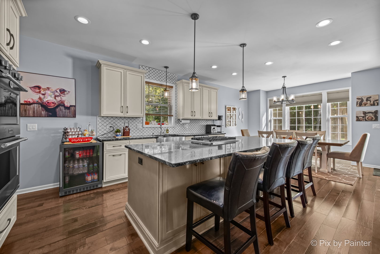 39247 Rangers Way Antioch, IL 60002 - Photo 16 of 53 a kitchen with stainless steel appliances granite countertop a stove top oven a refrigerator a sink and a dining table with wooden floor