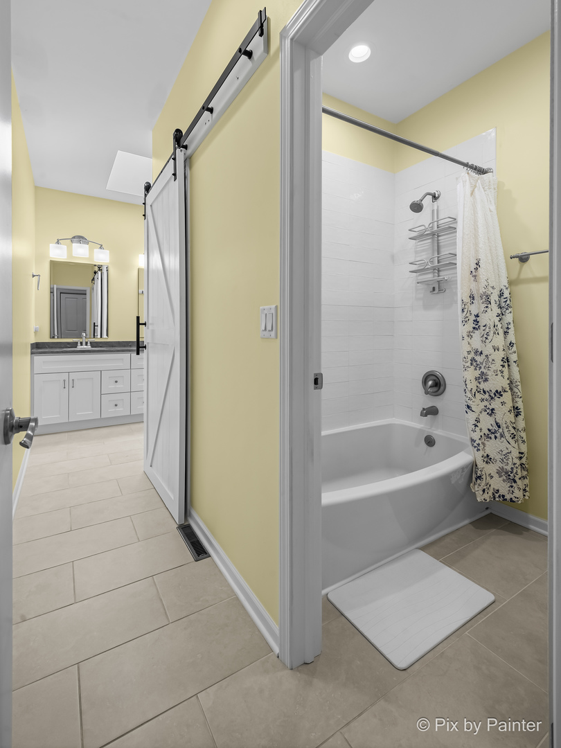 39247 Rangers Way Antioch, IL 60002 - Photo 40 of 53 a bathroom with a bathtub and a shower