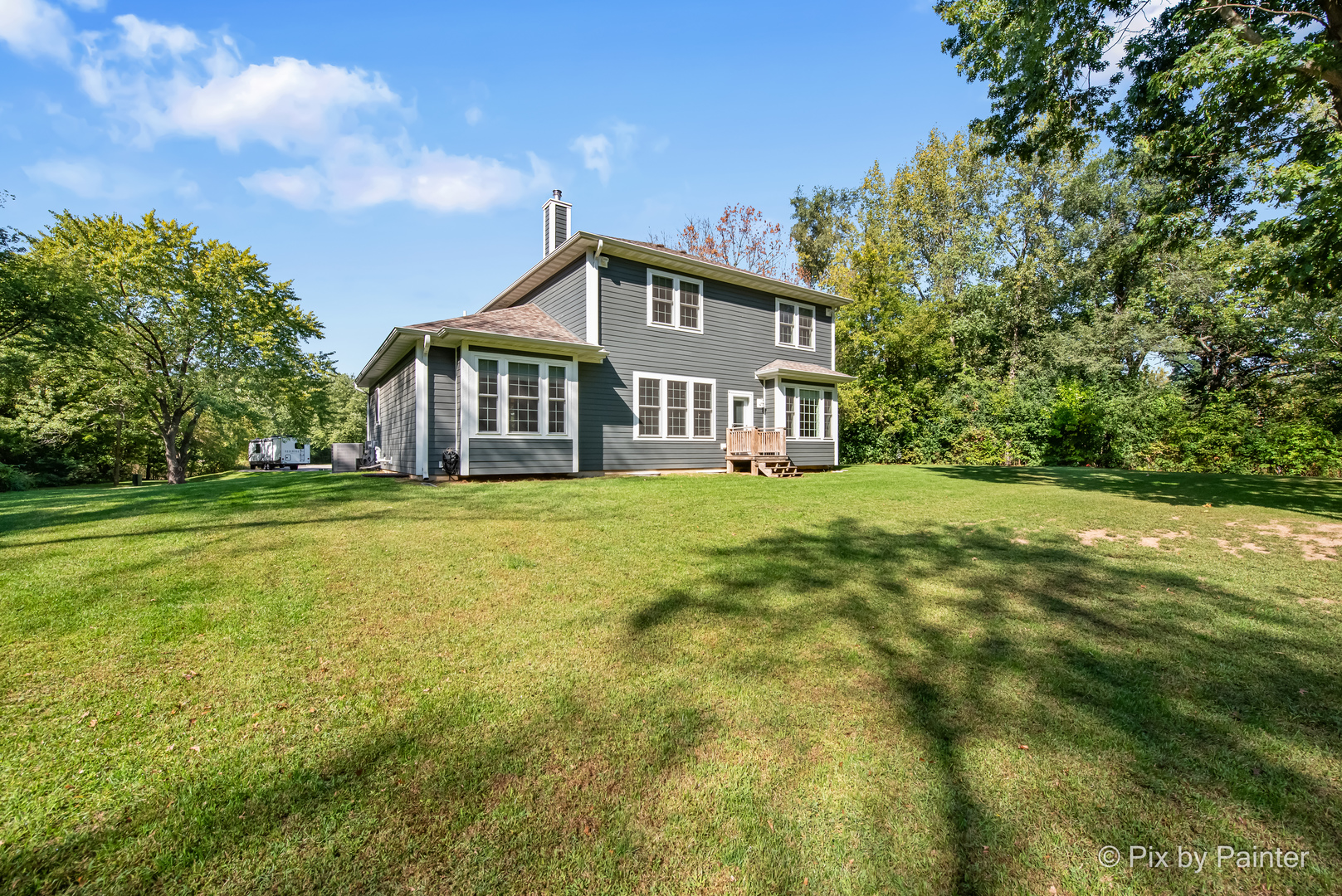 39247 Rangers Way Antioch, IL 60002 - Photo 10 of 53 a front view of a house with a garden