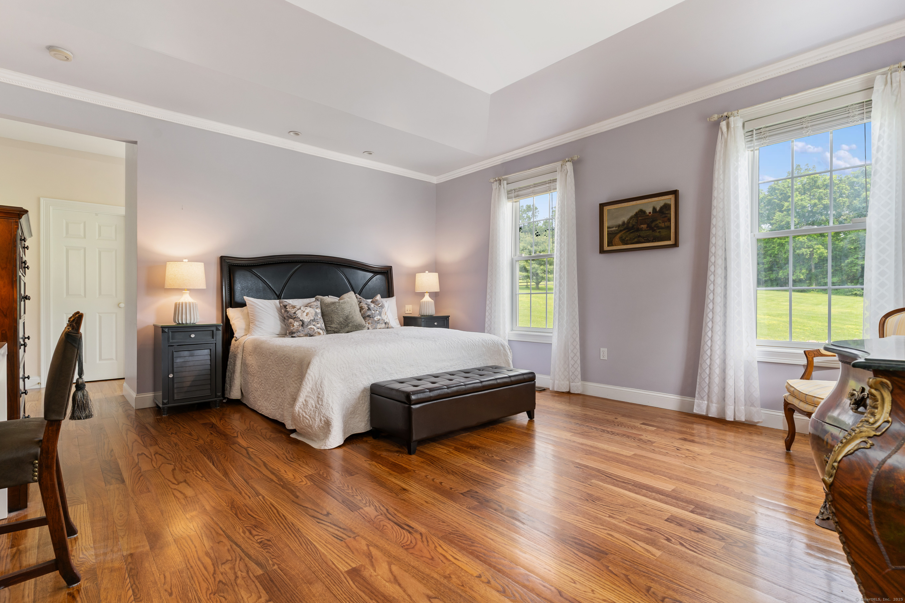 66-86 Bebbington Road Ashford, CT 06278 - Photo 14 of 39 a bedroom with a bed a table and chair with wooden floor