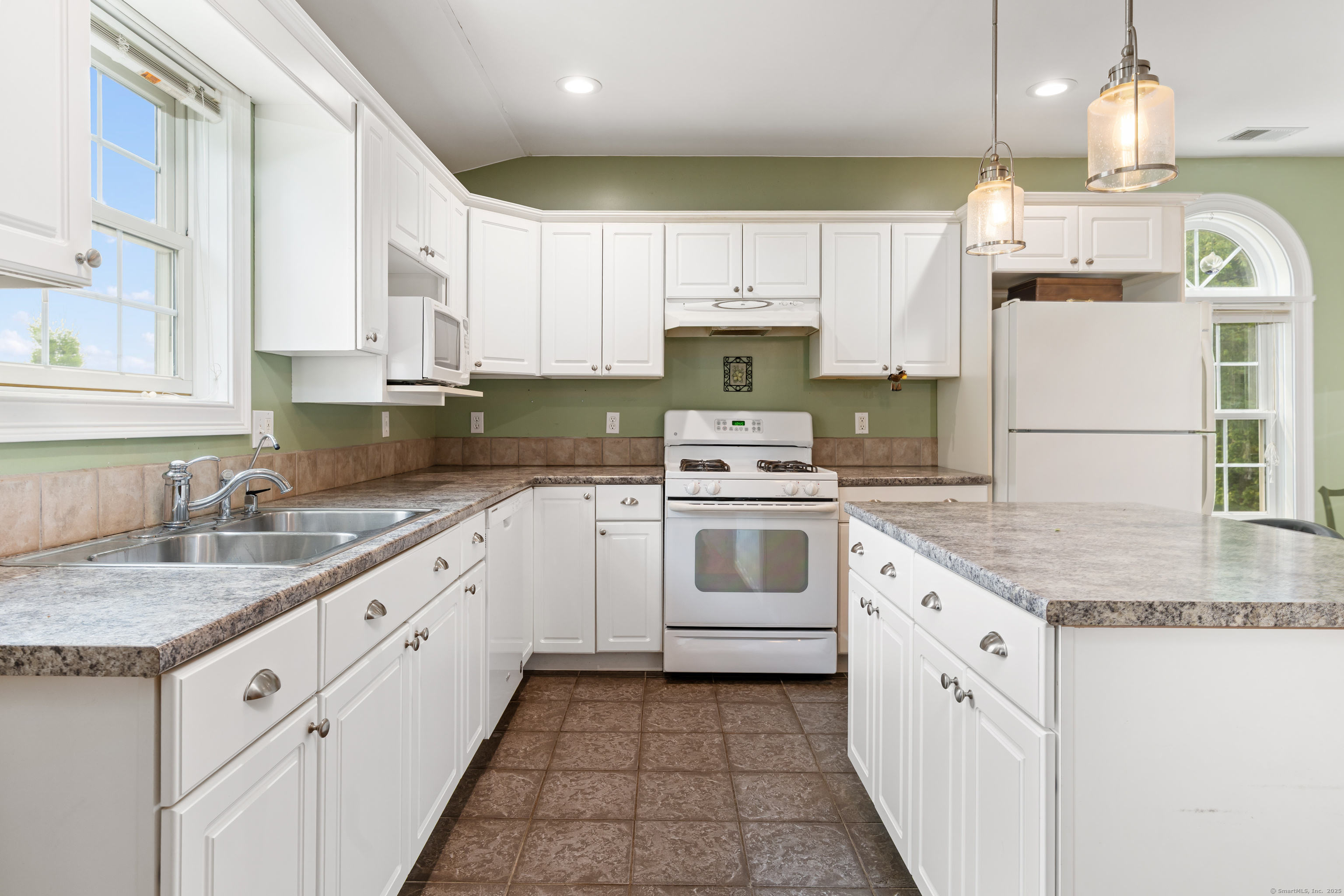 66-86 Bebbington Road Ashford, CT 06278 - Photo 20 of 39 a kitchen with granite countertop a sink stainless steel appliances and white cabinets