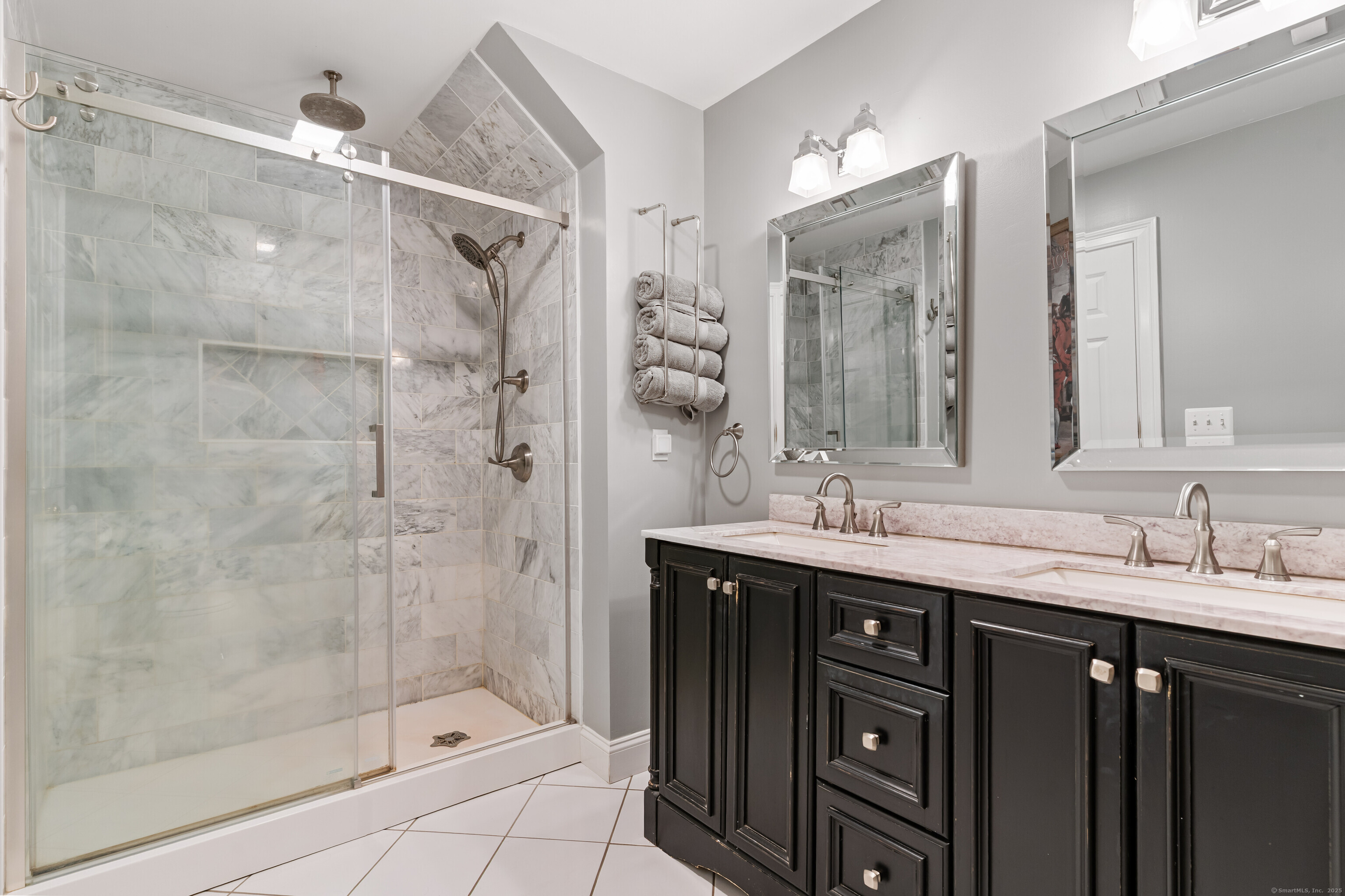 66-86 Bebbington Road Ashford, CT 06278 - Photo 21 of 39 a bathroom with a granite countertop sink a mirror and shower