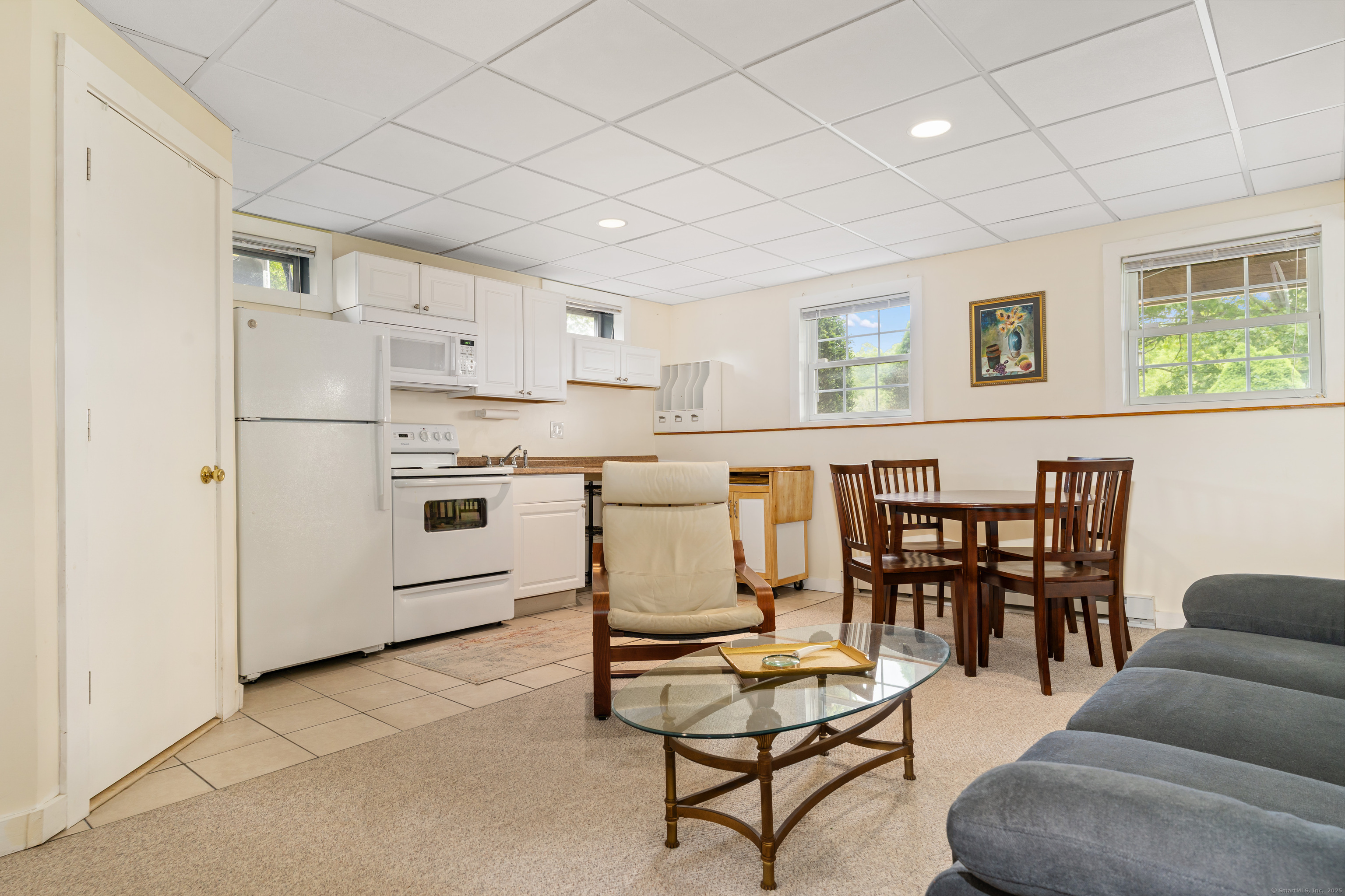 66-86 Bebbington Road Ashford, CT 06278 - Photo 24 of 39 a living room with couches chairs and kitchen view with wooden floor