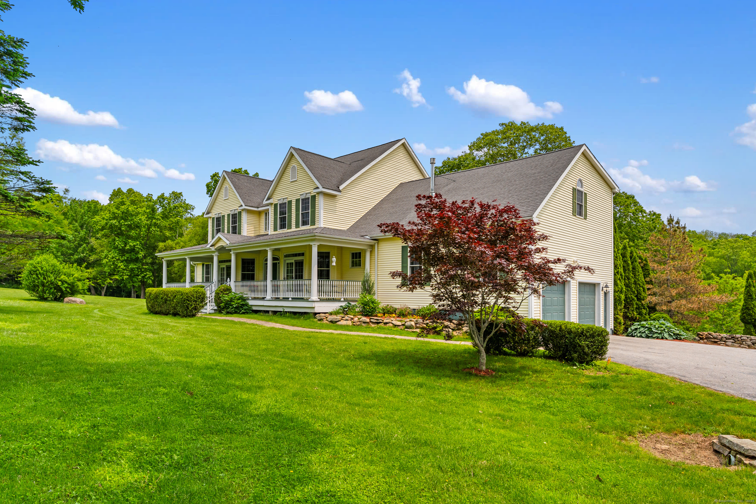 66-86 Bebbington Road Ashford, CT 06278 - Photo 4 of 39 a front view of a house with a garden and plants